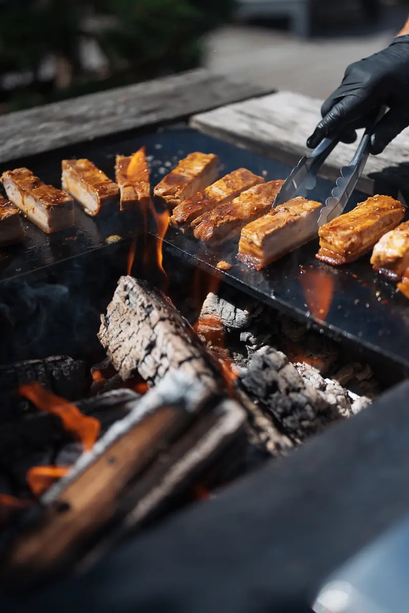 Des pièces de viande grillées au feu de bois